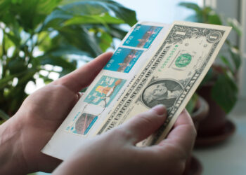 Is it possible to attach money to a letter instead of a stamp, and get it delivered?